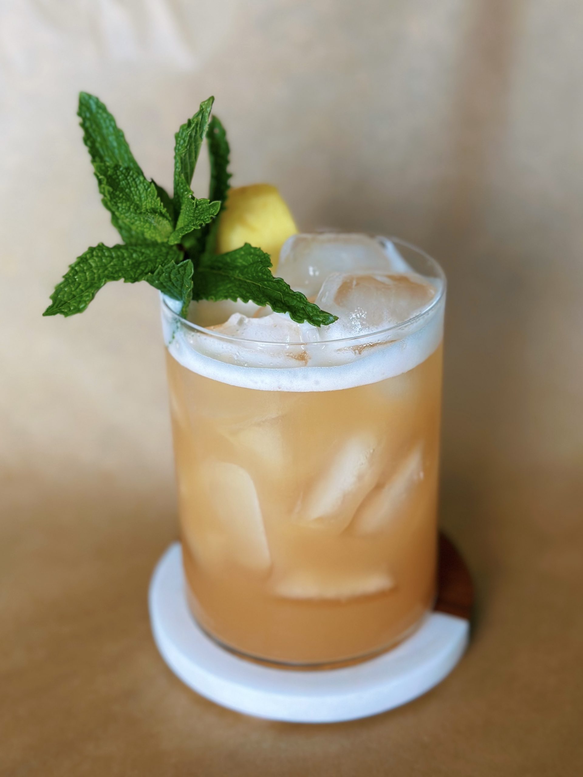 No Dark Clouds mocktail in a highball glass with mint and pineapple garnish