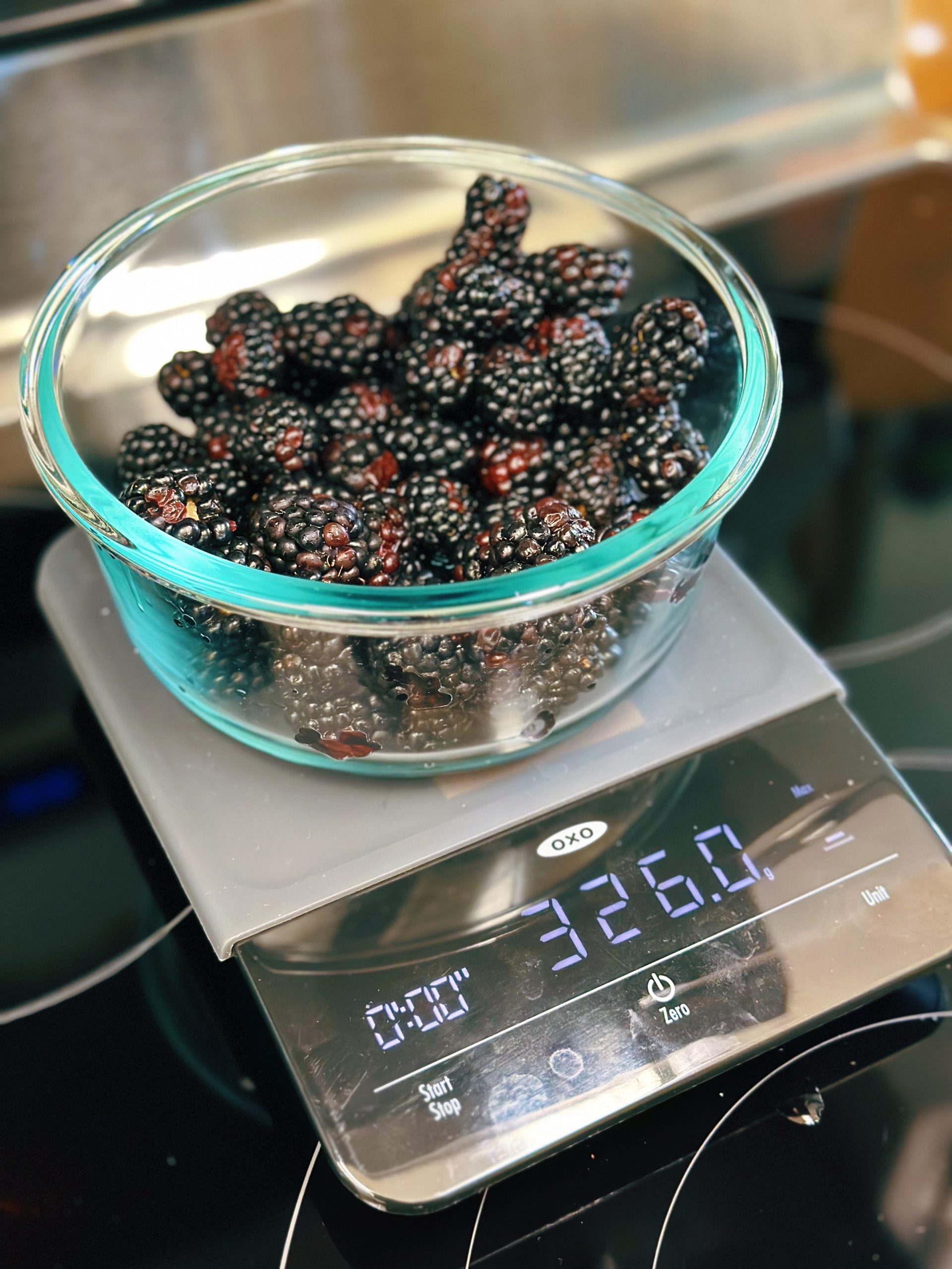 Fresh blackberries being weighed for use in a shrub.